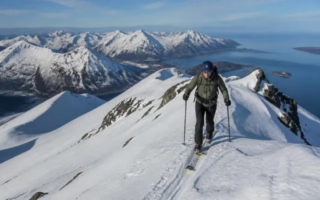 Skier on a snowy mountain ridge